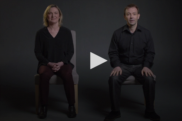 A man and woman sitting on a chair