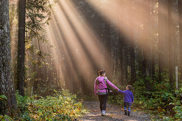 Mother and child walking in a forest