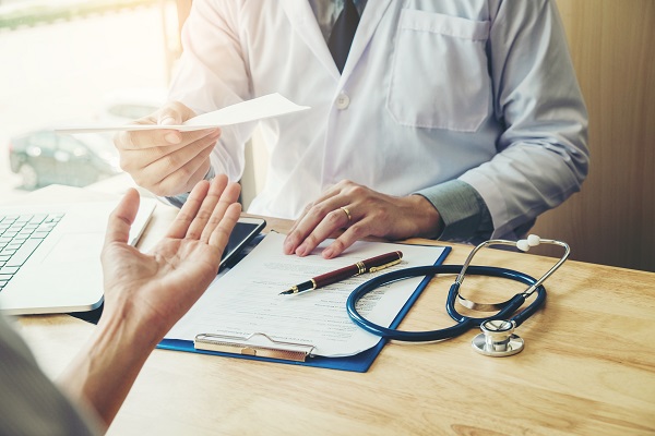 Clinician handing over signed paperwork